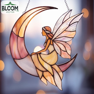 May include: Stained glass crescent moon with a fairy design. The fairy is seated on the moon, with detailed wings. The glass is a mix of pink, orange, and white, with a chain for hanging. The Bloom Vector logo is in the upper left corner.
