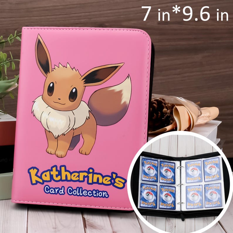May include: Pink card binder with a cartoon Eevee graphic and the text "Katherine's Card Collection." The binder measures 7 x 9.6 inches and contains card sleeves filled with trading cards.
