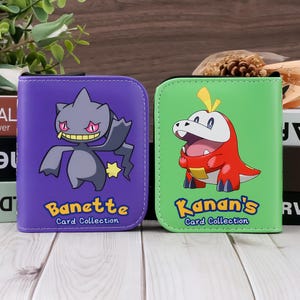 May include: Two card collection binders. One is purple with a Banette graphic and the text "Banette Card Collection". The other is green with a Kanan's graphic and the text "Kanan's Card Collection".
