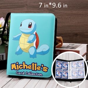 May include: A light blue card binder, 7 x 9.6 inches, featuring a cartoon Squirtle character. The binder has a black zipper and handle. The text "Michelle's Card Collection" is printed on the front. The binder is open, revealing card sleeves with cards.