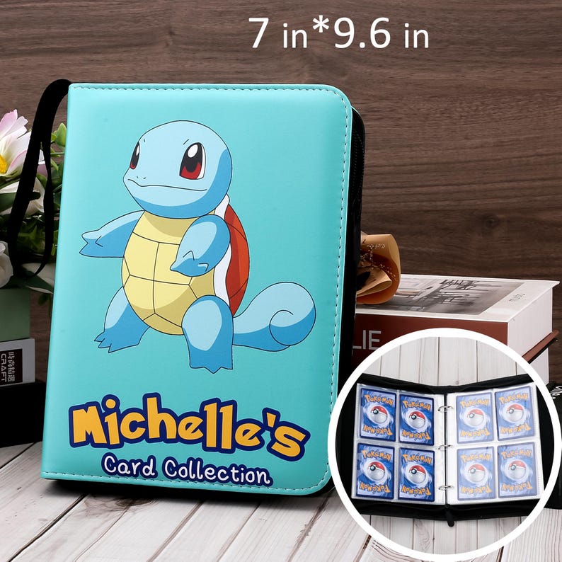 May include: A light blue card binder, 7 x 9.6 inches, featuring a cartoon Squirtle character. The binder has a black zipper and handle. The text "Michelle's Card Collection" is printed on the front. The binder is open, revealing card sleeves with cards.