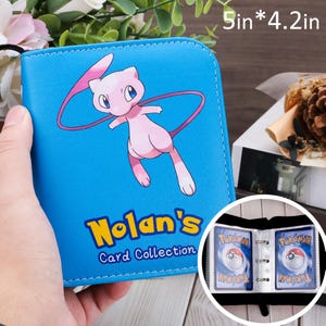 May include: A blue card binder with a pink cartoon character and the text "Nolan's Card Collection." The binder is 5 inches by 4.2 inches and has clear pockets for storing cards.