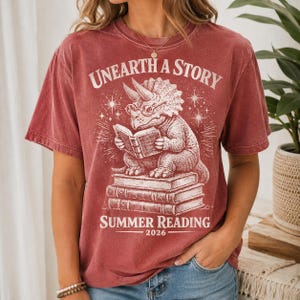 Comfort Colors Summer Reading 2026 Shirt Unearth The Story Dinosaur Book Lover Teacher Librarian Student Back to School Retro Reading Gift image 2