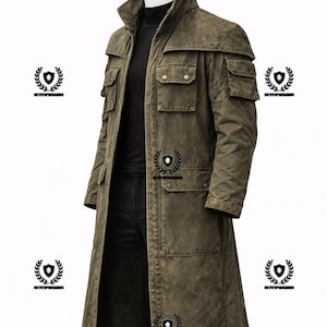 May include: A long olive green coat with multiple pockets and a high collar. The coat has a rugged, worn appearance and a button-down front. The coat is displayed on a mannequin against a white background.