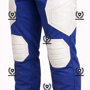 May include: Blue pants with white padded accents on the knees and thighs. The pants have a streamlined design, with the white padding providing a contrasting element. The pants appear to be made of a durable material.