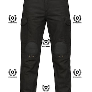 May include: Black cargo pants with reinforced knee panels and two side pockets. The pants have a decorative emblem on the waistband and are made of a durable fabric. The pants are designed for a rugged, utilitarian look.