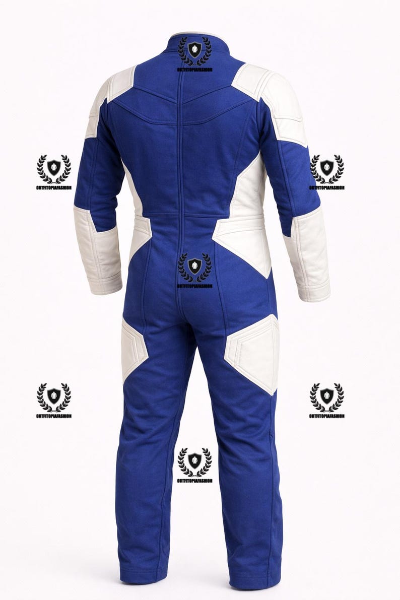 May include: A blue and white racing suit with a full-length zipper. The suit features white panels on the shoulders, arms, and legs, contrasting with the blue fabric. The back view shows the suit's design and stitching.