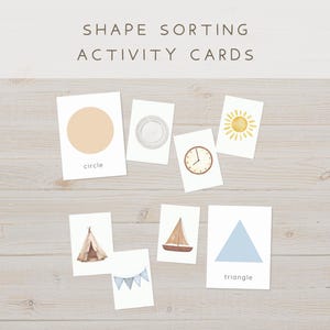 May include: Shape sorting activity cards with illustrations of a circle, plate, clock, sun, tent, sailboat, banner, and triangle. The word "circle" and "triangle" are written below the shapes. The text "SHAPE SORTING ACTIVITY CARDS" is at the top.