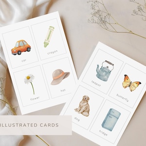 May include: Set of 48 illustrated cards featuring watercolor images of everyday objects. The cards include a car, crayon, flower, hat, teapot, butterfly, dog, and fridge. The cards are arranged on a neutral background.