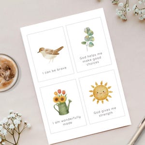 May include: A white rectangular card featuring four distinct watercolor illustrations and text. The top left shows a bird with the text I can be brave. The top right shows a green leaf sprig with the text God helps me make good choices. The bottom left shows a green watering can with flowers and the text I am wonderfully made. The bottom right shows a smiling sun with the text God gives me strength.