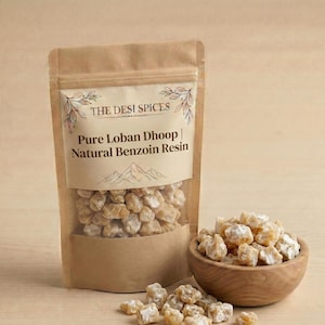 May include: A brown paper pouch labelled The Desi Spices Pure Loban Dhoop Natural Benzoin Resin containing small, irregular, translucent amber-coloured resin chunks. A small wooden bowl filled with the same resin sits next to the pouch.