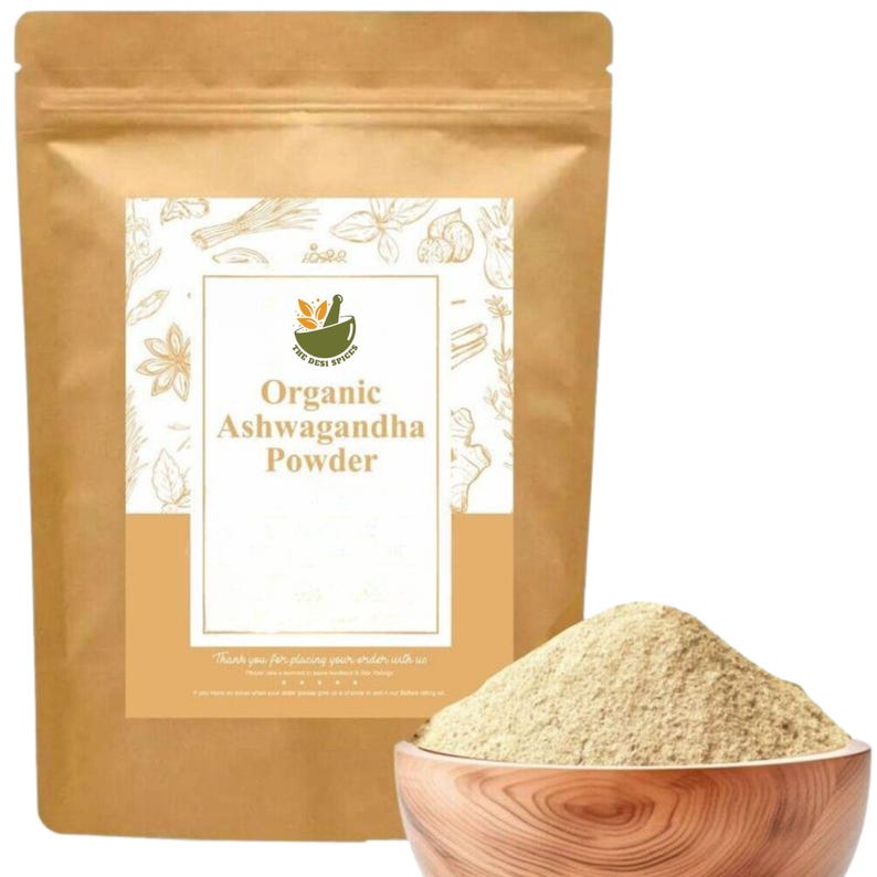 May include: A brown paper bag of organic Ashwagandha powder with a white label. A wooden bowl contains a pile of the light brown powder. The label includes the text "Organic Ashwagandha Powder".