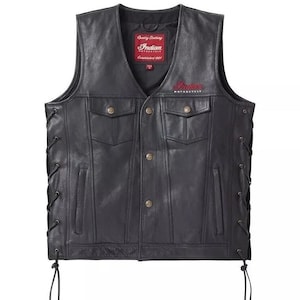 May include: Black leather vest with a V-neck, two chest pockets, and two lower pockets. The vest has button closures and side lacing. The Indian Motorcycle logo is displayed in red on the chest.