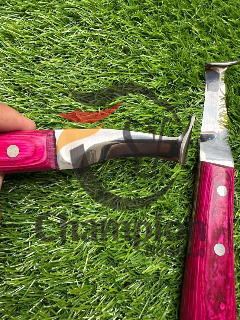 May include: Two hoof knives with bright pink wooden handles and silver blades. One knife has a curved blade, the other has a straight blade. The handles are secured with silver rivets. The knives are designed for farrier work.
