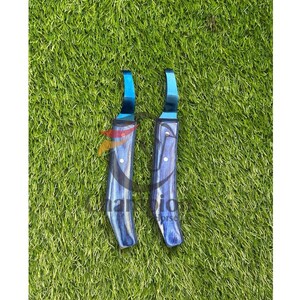 May include: Two hoof knives with blue blades and handles with a blue and gray wood grain pattern. The knives are designed for trimming horse hooves. The background is green grass.