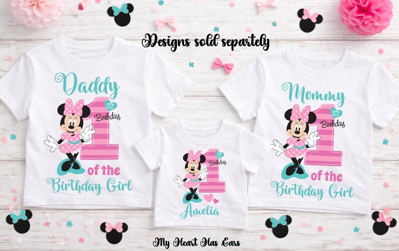 K&ouml;nnte beinhalten: Wei&szlig;e T-Shirts mit Minnie-Maus-Designs f&uuml;r einen ersten Geburtstag. Die Shirts sind mit "Daddy", "Mommy" und "Amelia" beschriftet, mit passenden Minnie-Maus-Grafiken und der Zahl "1". Rosa und t&uuml;rkisfarbene Akzente werden verwendet.
