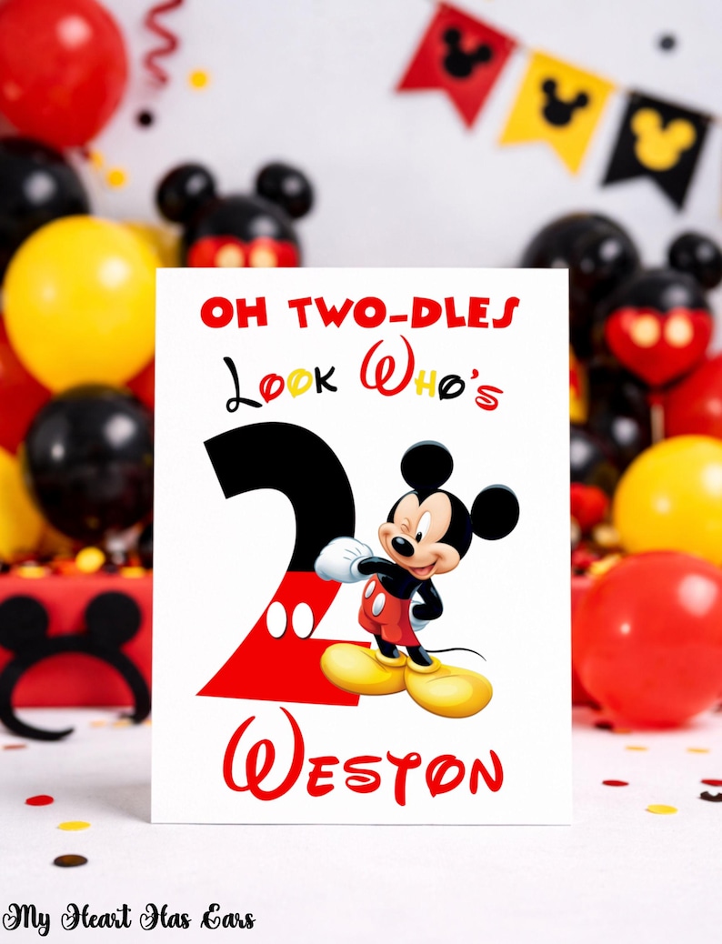 May include: A birthday card featuring Mickey Mouse with the text "OH TWO-DLES Look Who's 2 Weston" in red and black. The card is surrounded by red, yellow, and black balloons, and a Mickey Mouse-themed banner.