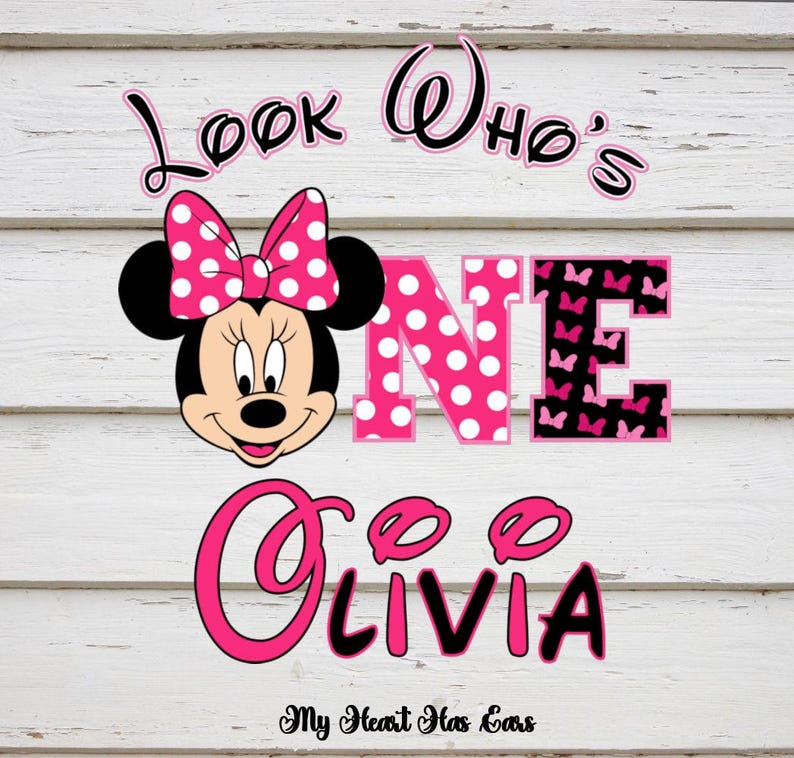 May include: A Minnie Mouse-themed design with the text "Look Who's One Olivia". The word "ONE" is in pink with white polka dots and black butterfly accents. The design includes a Minnie Mouse face with a pink polka dot bow.