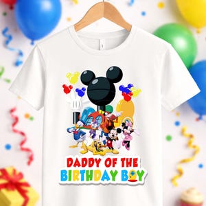 May include: A white short-sleeved t-shirt featuring a graphic of Mickey Mouse and friends, including Donald Duck, Daisy Duck, Goofy, Pluto, and Minnie Mouse. The text DADDY OF THE BIRTHDAY BOY is printed in colorful letters below the characters.