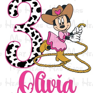 May include: A cartoon illustration featuring Minnie Mouse in a cowgirl outfit, holding a rope. A large number 3 with a cow print design and the name "Olivia" in pink are also present. The background is white.