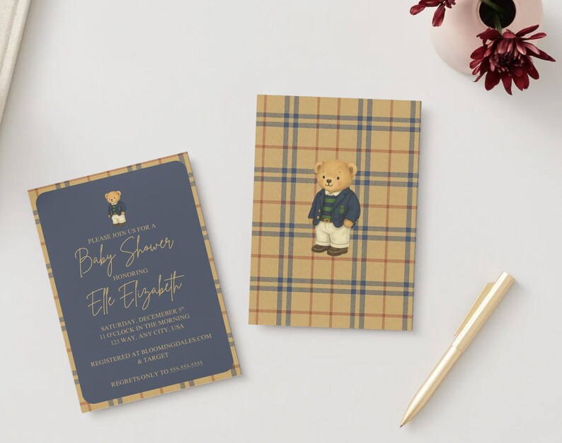 May include: Baby shower invitations featuring a teddy bear illustration. One invitation has a navy blue background with gold text and a teddy bear graphic. The other invitation has a plaid pattern with a teddy bear graphic. A gold pen and flowers are also in the image.
