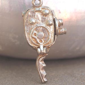 Old fashioned cine camera Chim vintage silver charm or pendant - Opening - Sunbathing woman