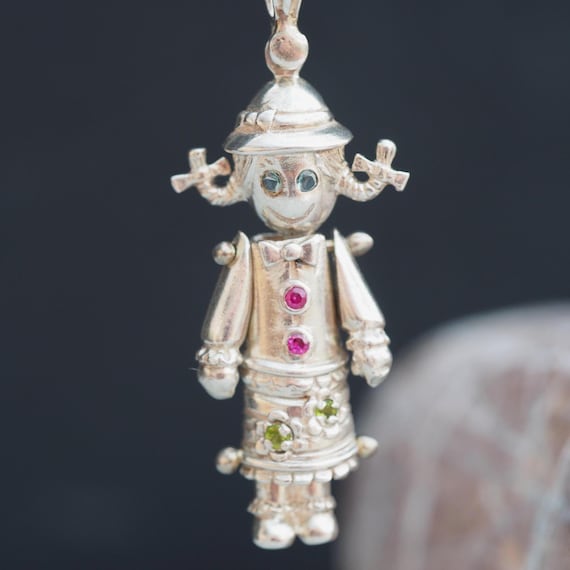 Rag doll articulated vintage silver and gem set pendant