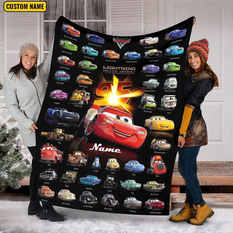 May include: A black fleece blanket featuring a large red Lightning McQueen car graphic, the number 95, and numerous smaller character cars from the Disney Pixar Cars franchise. The blanket includes a custom name field and the text Lightning McQueen.