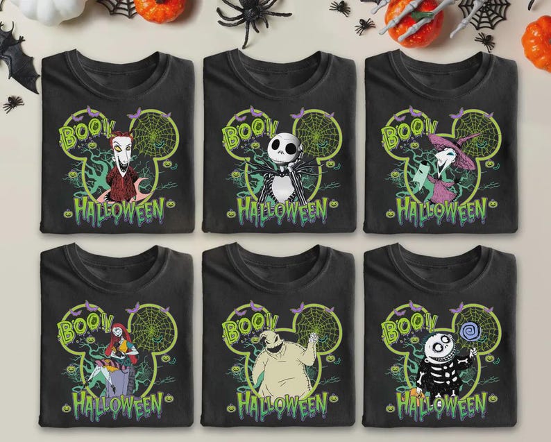 May include: Six black t-shirts with Halloween-themed graphics. Each shirt features a different character from The Nightmare Before Christmas, the word "BOO!" and the word "HALLOWEEN" in green. The designs are set within a Mickey Mouse head shape.