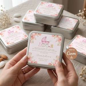 May include: Square silver metal tins featuring a custom label with a pink baby carriage illustration, floral accents, and text reading: Ten little fingers, ten little toes fill our hearts with love that overflow. We are excited to announce the birth of our baby girl, Elena Williams, blessed parents Ben and Lina.