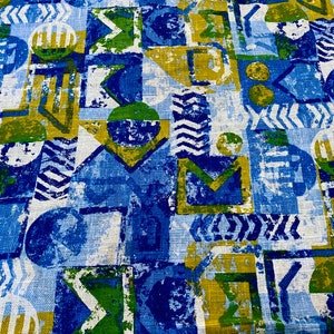 May include: Abstract geometric pattern fabric in shades of blue, green, and gold. The fabric has a textured, linen-like appearance.