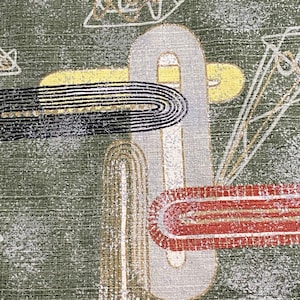 May include: Abstract geometric pattern on a green fabric with white, black, red, and yellow accents.