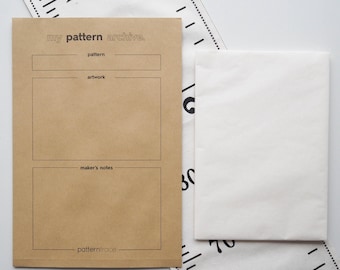 May include: A brown paper pattern archive envelope with the text "my pattern archive." and sections for pattern, artwork, and maker's notes. A white paper envelope and a measuring tape are also visible.