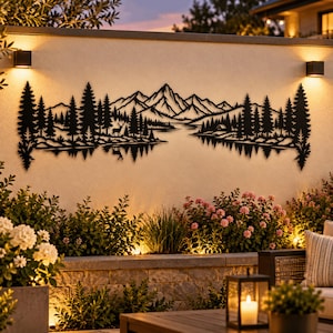 May include: A black metal wall art piece featuring a detailed landscape silhouette of jagged mountain peaks, a dense forest of pine trees, and a calm lake. The design includes a small deer standing near the water and a reflection effect.