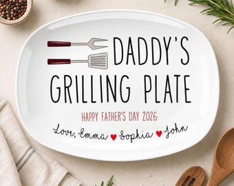 Puede incluir: Plato ovalado blanco con el texto "DADDY'S GRILLING PLATE" en negro, con un gráfico de tenedor y espátula. Incluye "HAPPY FATHER'S DAY 2026" y nombres. Un regalo para el Día del Padre.