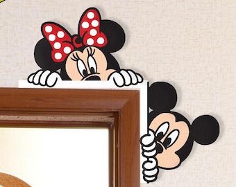 May include: Minnie Mouse and Mickey Mouse wall decals. Minnie is wearing a red polka dot bow. Mickey is peeking around a corner. The word "love" is spelled out with Mickey's hand and yellow letters.
