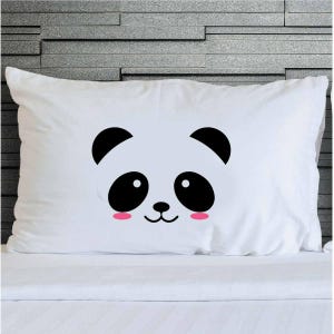 May include: White rectangular pillowcase with a panda face design. The panda has black ears, eyes, and nose, with pink cheeks. The pillowcase is on a white surface.