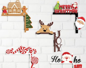 May include: A collection of Christmas-themed wooden corner decorations. Designs include a gingerbread house with gingerbread people, a reindeer, candy canes, and Santa Claus. The words "Merry Christmas", "JOY", and "Ho ho ho" are also featured.