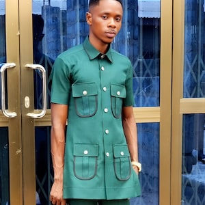 Jeeva Fashions New Stylish Partywear Formal Green Color Suiting Fabric Designer Safari Suit For Men.