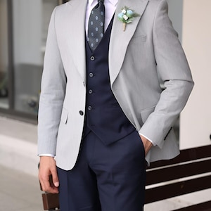 Jeeva Fashions New Stylish Partywear Formal Grey Color Designer 3 Piece Coat Pant Suit For Men.
