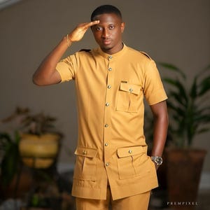 Jeeva Fashions New Stylish Partywear Formal Light Gold Color Suiting Fabric Designer Safari Suit For Men.