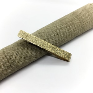 Brass tie clip with hammered texture includes polishing cloth