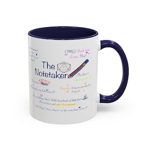 May include: White ceramic mug with a navy blue interior and handle. The mug features the text "The Notetaker" with various handwritten notes and illustrations, including a pencil and a die.