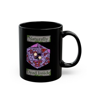 May include: Black ceramic mug with a purple, geometric design featuring a skull and various other illustrations. The mug has the text "Naturally" above the design and "Dead Inside" below it.
