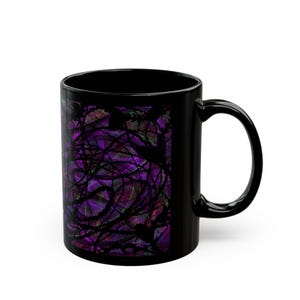 May include: Black ceramic coffee mug featuring a vibrant abstract design in shades of purple, green, and black. The design has a swirling, textured appearance. The mug has a standard handle.