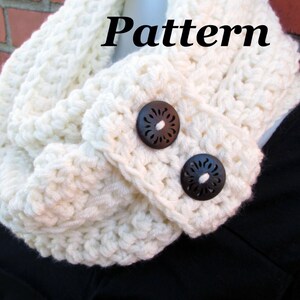 May include: A white crocheted infinity scarf with two brown wooden buttons. Crochet Pattern.