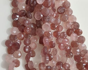 May include: A collection of faceted, reddish-pink gemstone beads. The beads vary in shade, from light to dark, and are cut to reflect light. Pink tassels are attached to the bottom of the strands. Suitable for jewellery making.