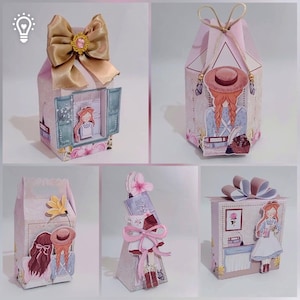 May include: Five decorative paper gift boxes in shades of pink and cream, featuring illustrations of a girl with braided hair, floral accents, and gold ribbon bows. The boxes display various shapes and designs, including window scenes and books.