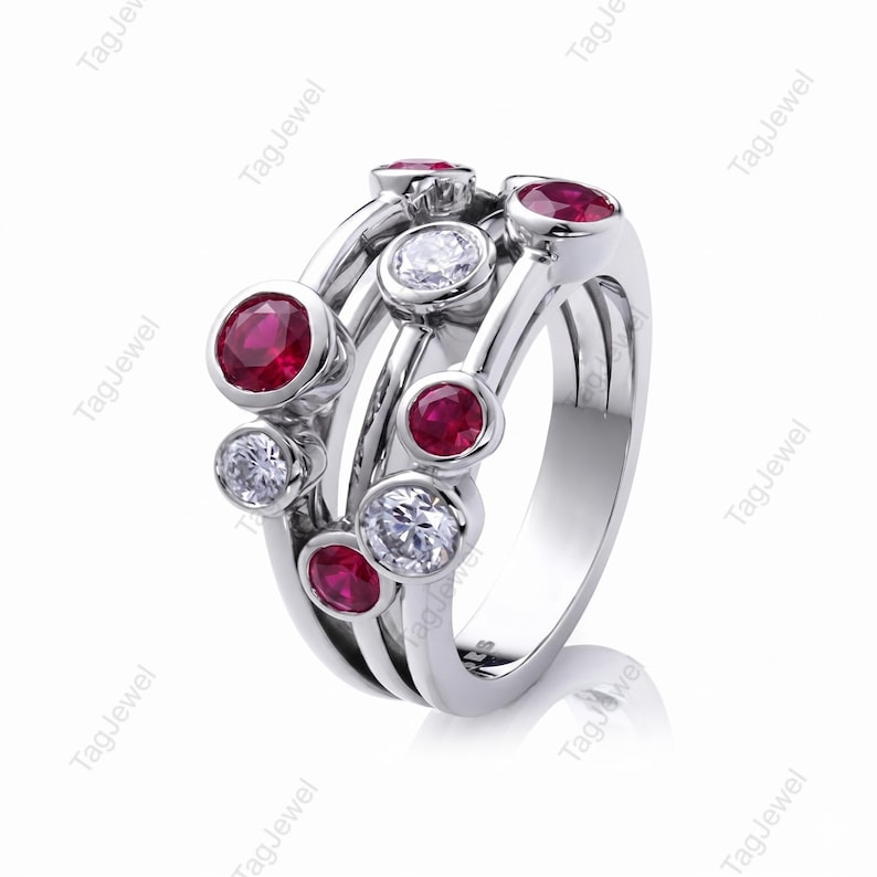 Handcrafted 925 sterling silver cluster ring featuring vibrant round lab-created ruby gemstones and sparkling white accent stones in a modern bubble-inspired bezel setting. This elegant July birthstone statement ring offers contemporary style for everyday wear, anniversaries, birthdays, engagements, Valentine's Day, Mother's Day, and thoughtful gifts for women.