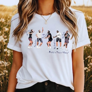 May include: A white short-sleeved t-shirt featuring a graphic of five illustrated figures in various dance poses. The text labels include The Kungfu, The Cowboy, The Lawnmower, The Dumptruck, The Zesty, and the phrase ...Posty's Dance Vibes!